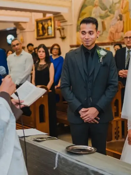 The bride and groom listening intently to the priest's words as they stand at the altar, ready to exchange their vows.