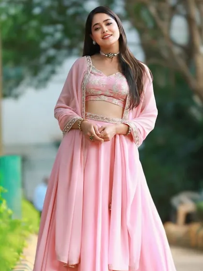 The full view of the flowing pink lehenga worn by Mokshitha Pai.