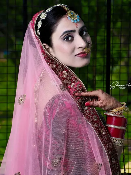 A side profile of the bride peeking from behind her veil, creating a sense of mystery and elegance.