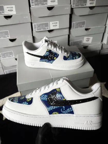 A full view of the galaxy custom sneaker held up.