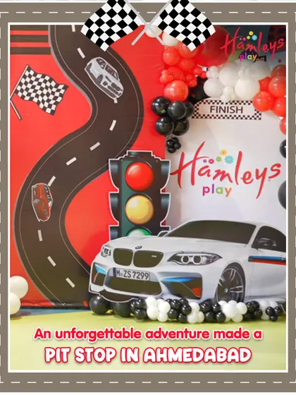 An unforgettable adventure made a pit stop in Ahmedabad! This photo shows the fantastic setup for our Mini Racers event, complete with a racetrack backdrop and traffic light decorations.