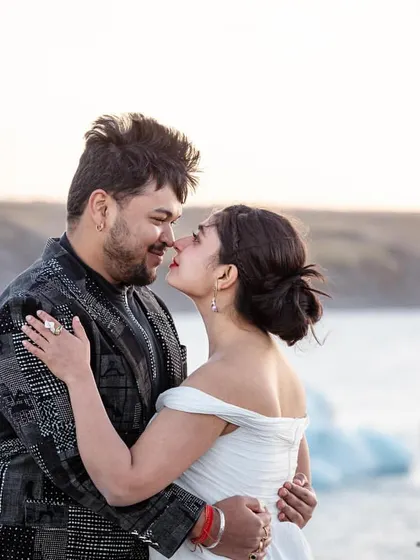 An intimate shot of Shree and Abhishek. This shows how his unique printed jacket stands out yet harmonizes with her simple white dress against the icy backdrop.