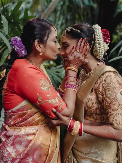 A mother's love captured in a single frame. This touching moment between the bride and her mother, both dressed in beautiful South Indian silks, is one of the most precious memories from the wedding day.