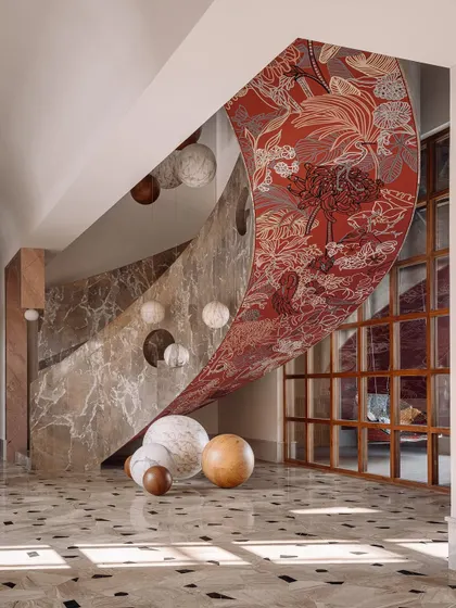 Another view of the stunning mural by House of Berserk, which unfurls like a massive, artistic scroll along the curve of the staircase.