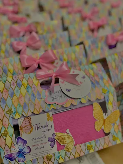 A beautiful butterfly-themed hamper for a first birthday. The pastel box with a scalloped edge is filled with goodies and decorated with 3D butterflies.