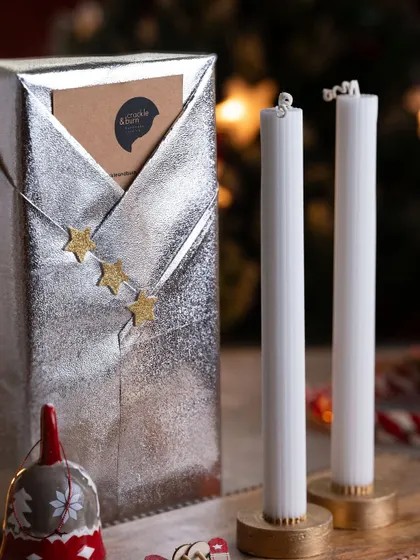 Gift wrapping can also be sleek and modern. This elegant silver paper with simple star accents is paired with my handmade tapered candles for a sophisticated and minimalist holiday gift.