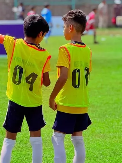 Two teammates communicating on the field during a match. Teamwork and communication are vital for success.