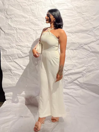 A sleek and simple white halter-neck jumpsuit. This is a perfect example of a one-and-done outfit that looks incredibly chic and polished for any formal event.