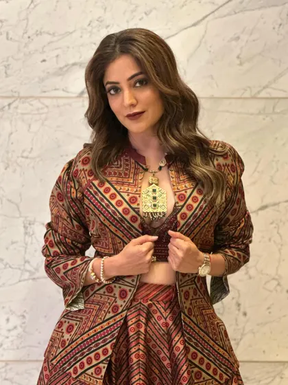 The brown tones in her hair are highlighted beautifully by these soft waves. It's a versatile look that's both casual and chic.