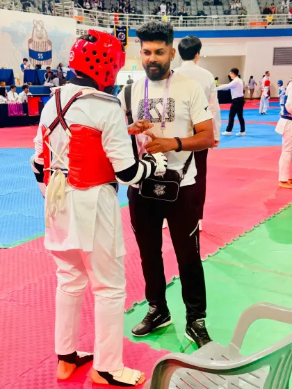 Giving last-minute advice to my student before his Kyorugi match.