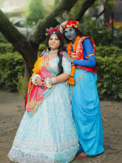 A full-length shot of the Radha-Krishna pair, showing the complete costumes and makeup.