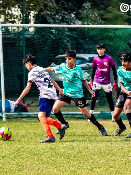 A defender closes in as an attacker advances towards the goal.