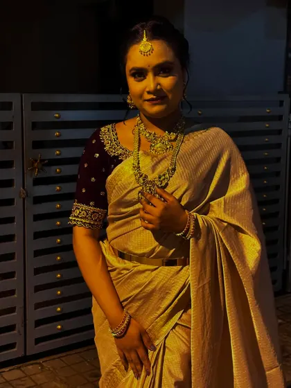 A direct portrait from the same evening shoot, highlighting the flawless base and traditional gold jewellery.