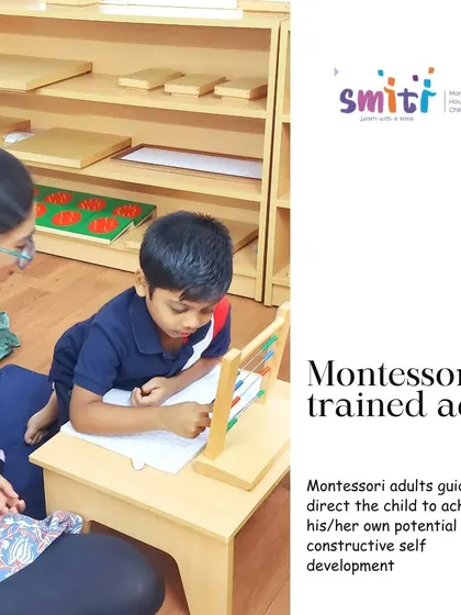 A Montessori-trained adult guides a child through an arithmetic exercise using the abacus. Our teachers act as facilitators, observing each child's needs and introducing new concepts when they are developmentally ready.