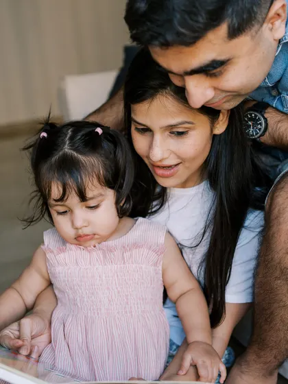 A family reading a book together. A simple, everyday activity that makes for a heartwarming and authentic family photo.