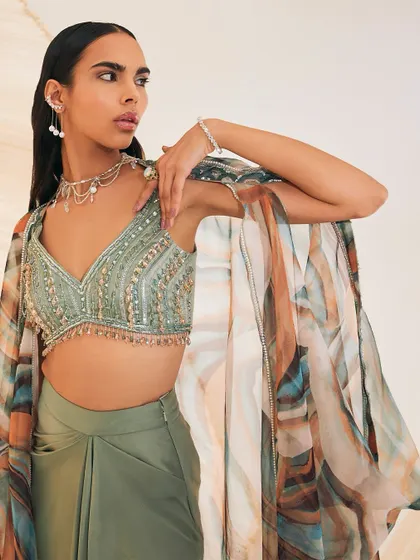 A closer look at the Vivien Cape Set, showing the delicate embellishments on the silky organza cape and the tassel details on the blouse.