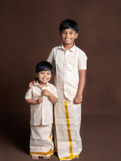 Two brothers, united in tradition. Dressed in matching veshtis, their bond and shared smiles are beautifully captured in this classic sibling portrait.