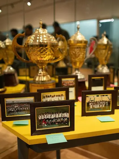 Another view of our legacy. Framed photos of past teams sit alongside the cups they won, connecting our current players with the history of the club they represent.