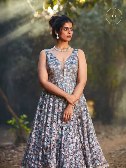 The beauty of this floral gown is in its details. The sheer illusion neckline and the way the light catches the embroidery are just exquisite.
