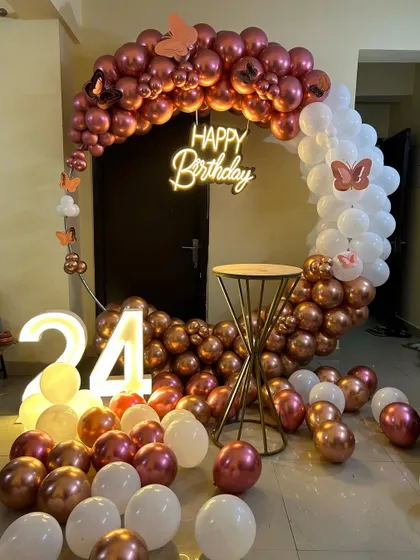 This is a duplicate of ID 10, 57, 81, 120, 210. An elegant and modern ring backdrop is perfect for home celebrations. The setup features a circular frame with a rose gold and white chrome balloon arrangement, a 'Happy Birthday' neon sign, and a light-up marquee number '24'.