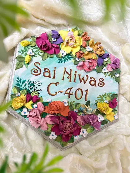 An angled shot of the hexagonal nameplate, highlighting the texture and depth of the floral sculptures.
