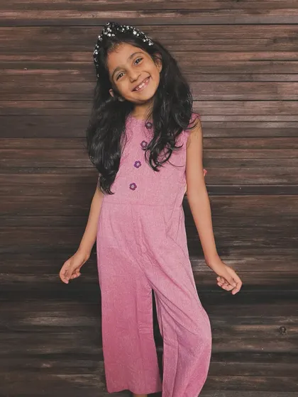 Say hello to endless fun and effortless style! This adorable pink jumpsuit is designed for little ones who love to move, play, and sparkle, with sweet floral buttons for a charming touch.