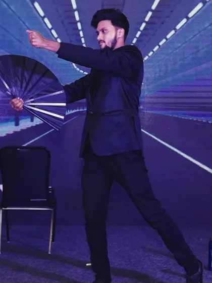Caught in the act during a corporate performance. I use a mix of classic magic, like the fan production, and modern mentalism to create a dynamic and engaging show for employees.