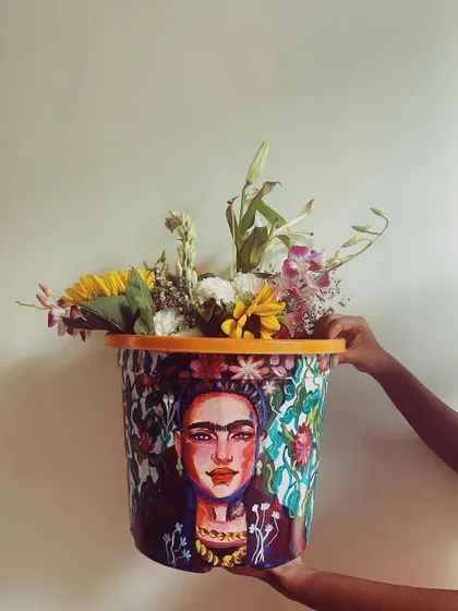 A different view of the Frida Kahlo planter, showing how the artwork looks in a different light. The piece is designed to be a captivating centerpiece filled with flowers or a plant.