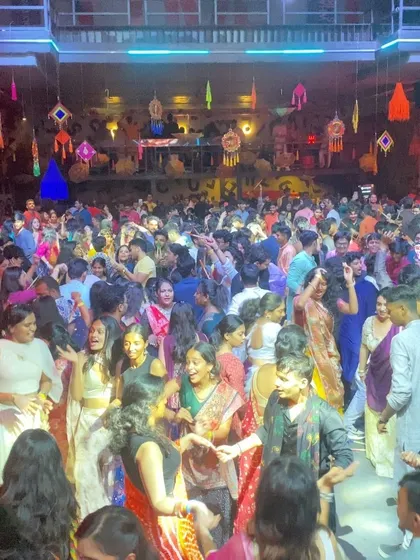 A close-up of the happy faces in the crowd, dancing and enjoying the festive music. This is what a successful Garba night looks like.
