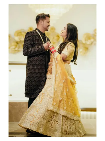 A romantic and playful shot of the couple. The bride's twirl and the way they look at each other create a dynamic and loving image.