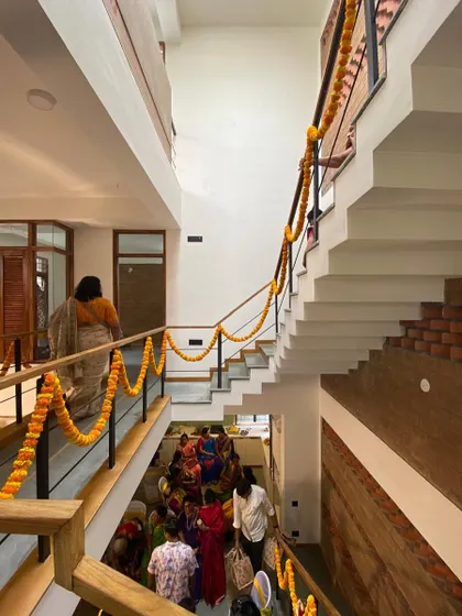 A view from the top of the stairs during a housewarming, showing the multi-level design filled with family and friends. Our goal is to create homes that are perfect for both quiet living and joyful gatherings.