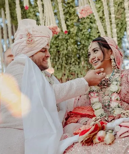 A candid shot of the bride and groom during their ceremony, surrounded by the natural beauty of the tree and our floral design.