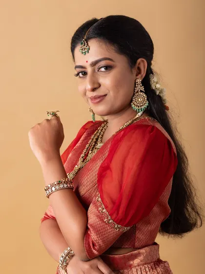 A smiling portrait. The makeup is soft and enhances her natural beauty, creating an approachable and elegant look for the brand.