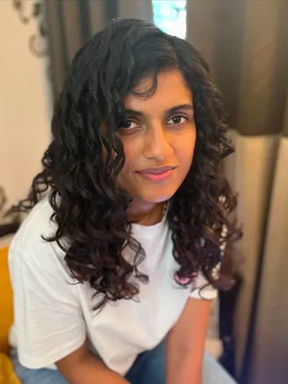 A layered cut designed to add volume and definition to long, curly hair.