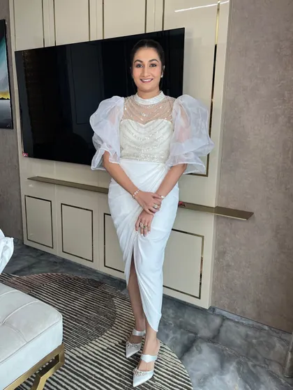 The full look, from the architectural white dress to the sleek hair and makeup. Perfect for a modern, high-fashion event.