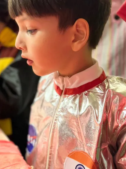 A close-up of the astronaut's face, showing his complete concentration and fascination with the hands-on activity.