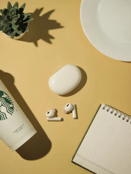 A top down view of the realme earbuds flatlay, showing all the elements arranged neatly on a yellow background.