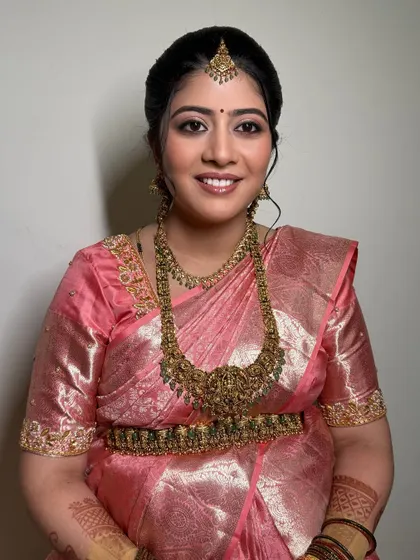 A smiling portrait of the mom-to-be. Her makeup is fresh and radiant, giving her a beautiful glow.