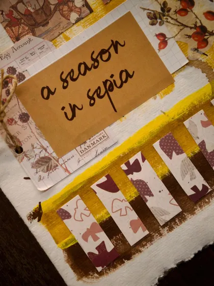 A close-up of our handmade 'A Season in Sepia' cocktail menu. This image highlights the scrapbook-style artistry, turning a simple menu into a nostalgic and tactile experience.