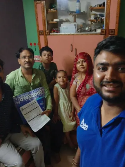 A family with young children poses with our team and their new solar plan. We are making solar accessible for everyone.