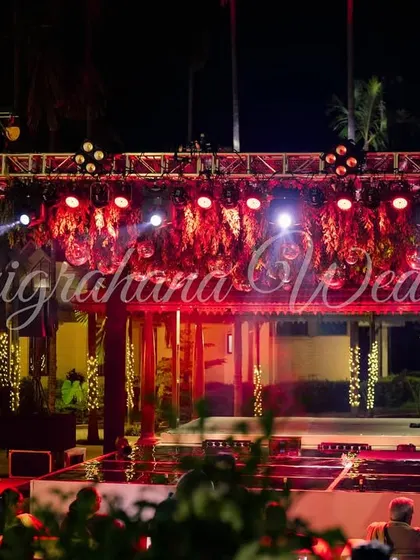 A wide shot of a Sangeet stage setup with a professional lighting truss, ready for a night of performances and partying.