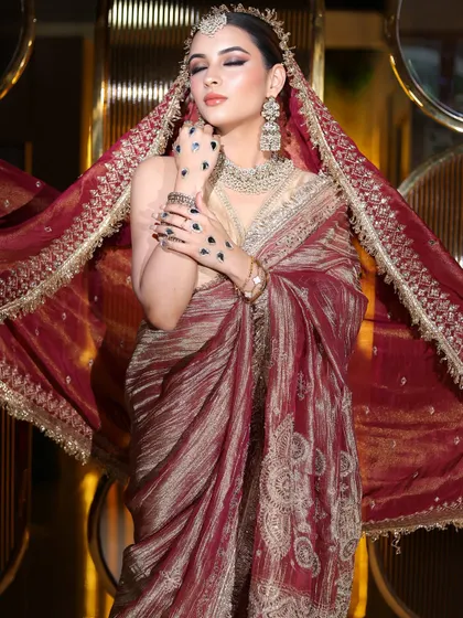A dramatic pose with the dupatta flowing. The makeup remains the focus, with a strong contour and bold eyes.