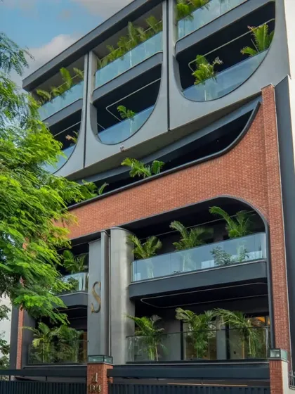 Another angle of the completed geometric facade, showcasing how the structure interacts with natural light. The design integrates planters on the balconies, adding a touch of green to the urban environment.