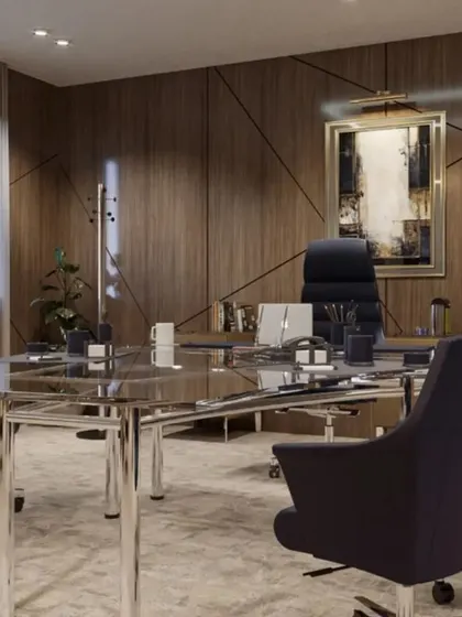 This conference room within an executive suite is designed for decision-making, featuring a sleek glass and chrome table surrounded by comfortable, professional seating. The wood-paneled walls add a sense of warmth and gravitas to the meeting space.