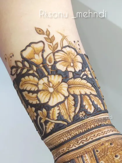 This design showcases a stunning floral cuff on the wrist. The bold, dark background makes the flowers pop, creating a dramatic and beautiful statement piece.