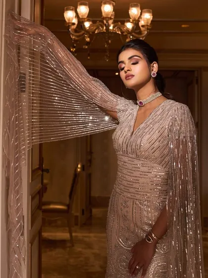 A throwback to Manisha's stunning engagement look. This shimmering Falguni Shane Peacock gown with cape sleeves is a timeless piece that still looks radiant.
