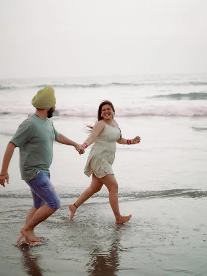 A candid moment of running and laughing by the water. The motion and genuine smiles make this a lively and joyful memory from their Goa trip.