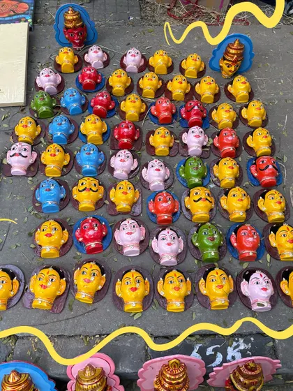 Colorful Thanjavur dolls, with a yellow doodle to highlight their craftsmanship.