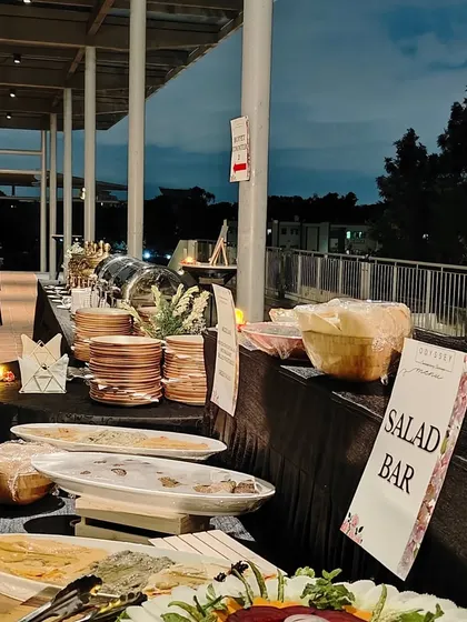 A salad bar and buffet setup for an evening event. We offer a range of fresh salads and hot dishes to create a balanced and satisfying meal for your guests.