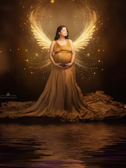 Explore our packages to get your maternity session done with stylish fabric drapes and wings, like this angelic portrait with a water reflection.